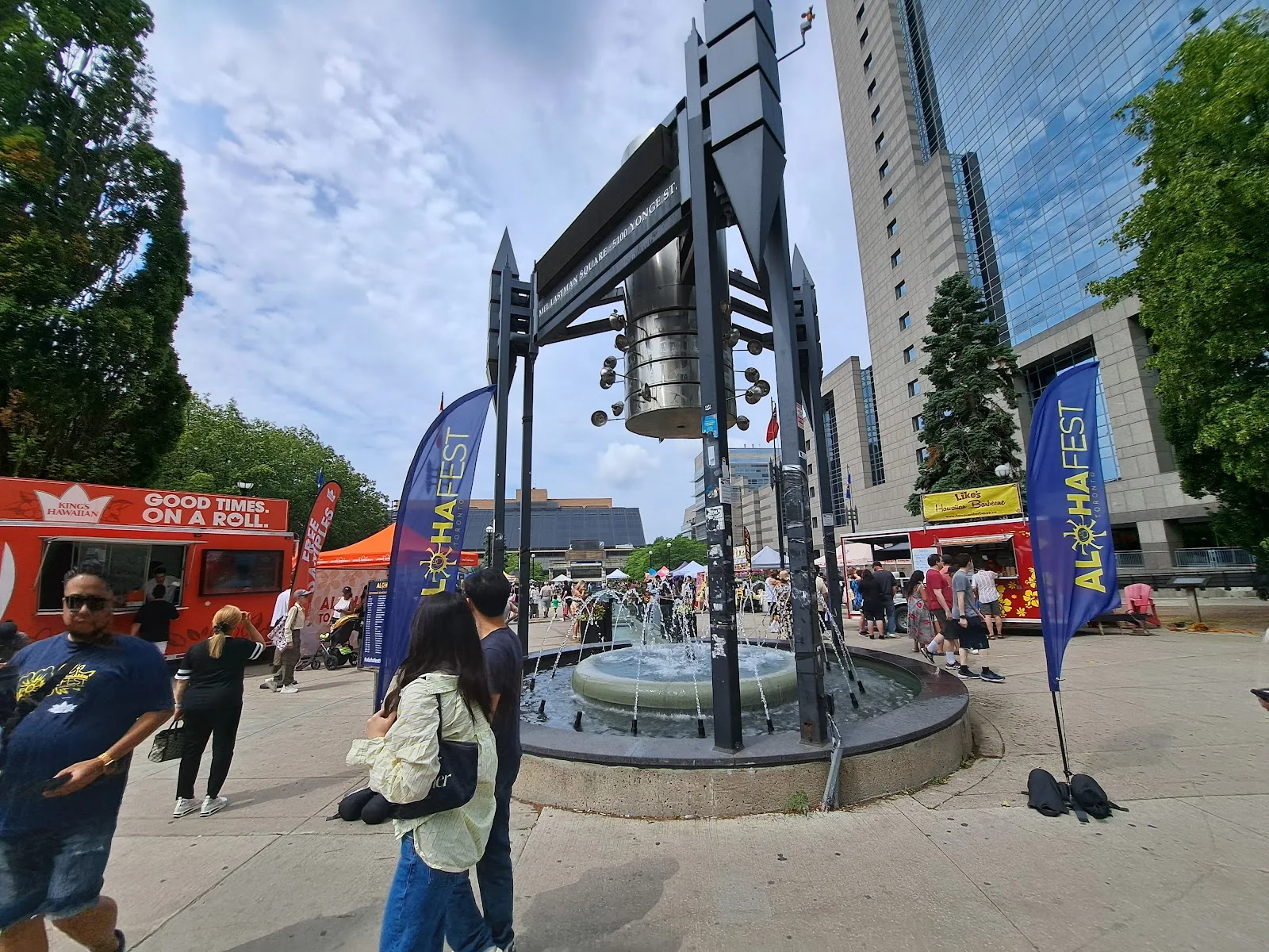 Summer festival day at Mel Lastman Square in North York — food trucks, festival flags and the fountain at 5100 Yonge Street, the flagship Canada Day 2026 venue