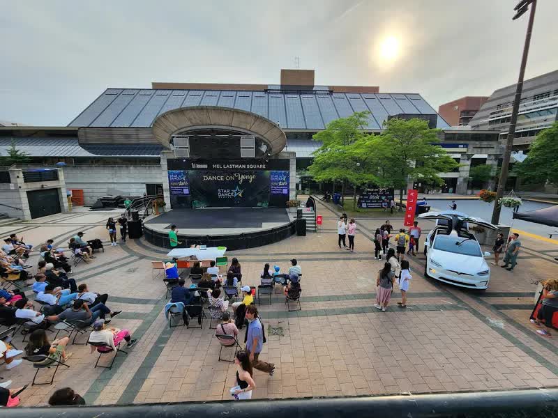 The outdoor stage and plaza at Mel Lastman Square in North York, with an audience seated in front of the stage