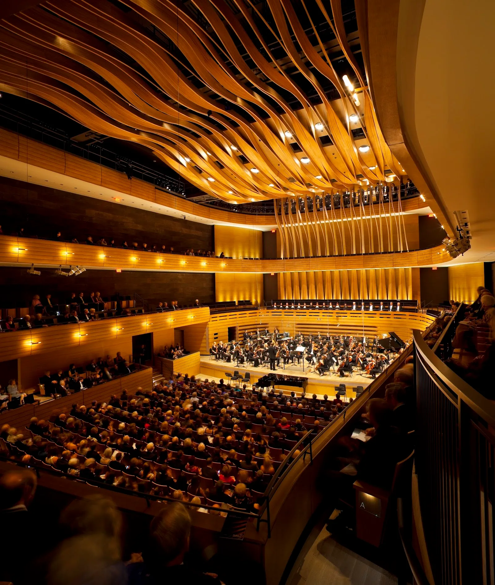 Koerner Hall in warm wooden tones during a full-house concert — home to the festival's biggest 2026 Koerner shows (Hiromi, Cassandra Wilson, Emilie-Claire Barlow), one Line 1 ride from North York