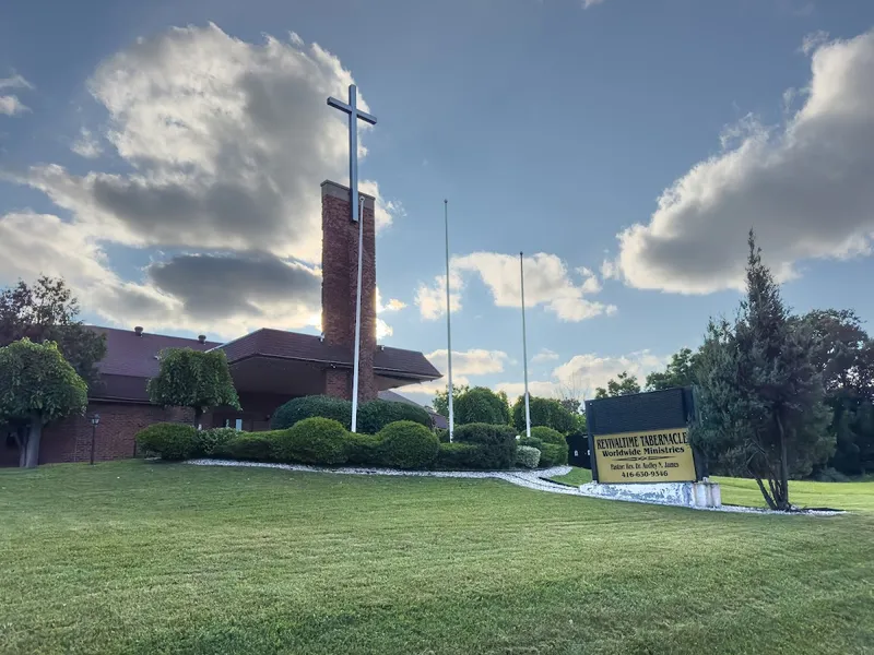 Revival Time Tabernacle exterior with cross at golden hour