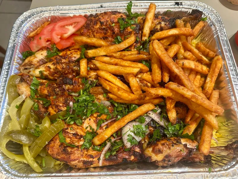 Farooj Abo Alabed grilled chicken platter with fries herbs and pickled peppers at 2387 Lawrence Ave E Scarborough